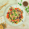 Lauwarmer Reisnudelsalat, asiatisch, mit Gemüse und Dressing aus Sojasoße, Erdnussmus und Koriander