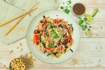 Lauwarmer Reisnudelsalat, asiatisch, mit Gemüse und Dressing aus Sojasoße, Erdnussmus und Koriander